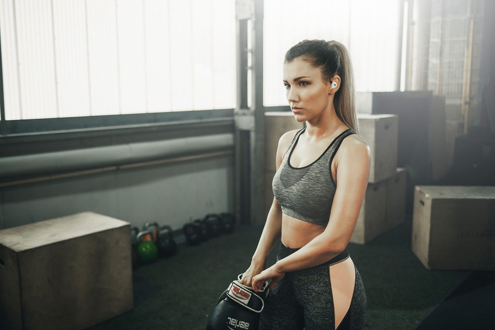 Crossfit Sportlerin zieht sich Boxhandschuhe an